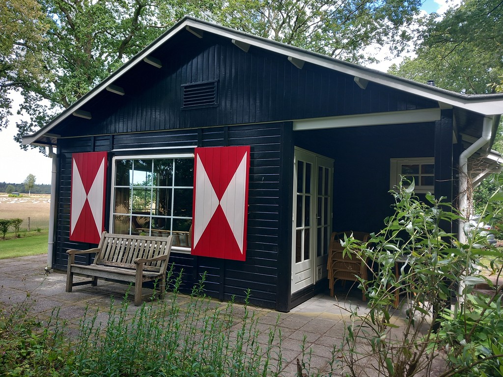 Boshuis met uitzicht, tuinbank voor het huis en authentieke rode luiken, perfect voor een gezellige sfeer.